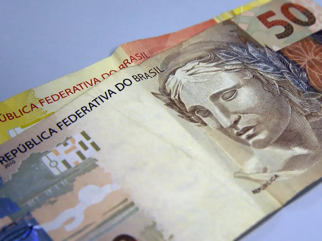 Nota de 50 reais na frente de nota de 20 reais